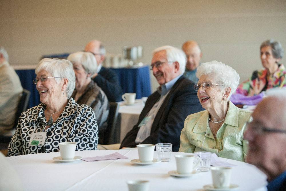 Grand Forum members smile during a lecture